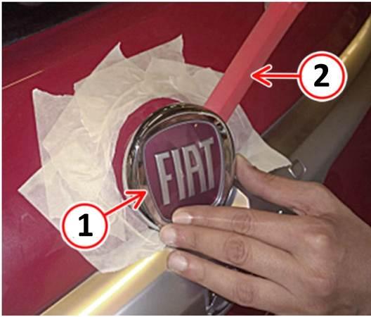 Fig. 1 Apply Tape To Protect Surface And Remove Loose Fiat Emblem